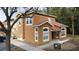 Two-story house with orange exterior, tile roof, and landscaping at 1001 Park Ridge Cir, Kissimmee, FL 34746