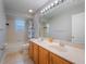 Bathroom with double sinks, wood cabinets and bathtub at 10125 Canopy Tree Ct, Orlando, FL 32836