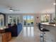 Living area with pool access and open kitchen views at 10125 Canopy Tree Ct, Orlando, FL 32836