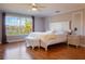 Spacious main bedroom features a plush bed and tranquil lake views at 10125 Canopy Tree Ct, Orlando, FL 32836