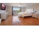 Main bedroom with hardwood floors, large window, and lake view at 10125 Canopy Tree Ct, Orlando, FL 32836