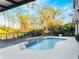 Inviting pool with waterfall feature and spacious deck at 10125 Canopy Tree Ct, Orlando, FL 32836