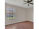 Bedroom with hardwood floors, large window, and ceiling fan at 1101 Swanson Dr, Deltona, FL 32738