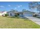 Single-story home with a white garage door and landscaped lawn at 1101 Swanson Dr, Deltona, FL 32738