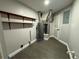 Clean laundry room with shelves, water heater, and modern flooring at 1461 Lancelot, Casselberry, FL 32707