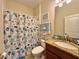 Bathroom with shower, toilet and seashell theme decor at 1506 Bunker Dr, Davenport, FL 33896