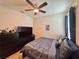 Bedroom with a king-size bed, dark dresser, and ceiling fan at 1506 Bunker Dr, Davenport, FL 33896