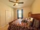 Bedroom with a king-size bed, wooden furniture, and ceiling fan at 1506 Bunker Dr, Davenport, FL 33896