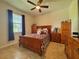 Bedroom with a double bed, wooden furniture, and ceiling fan at 1506 Bunker Dr, Davenport, FL 33896