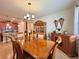 Elegant dining room featuring a large wood table, buffet, and chandelier at 1506 Bunker Dr, Davenport, FL 33896