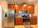 Modern kitchen with stainless steel appliances and granite countertops at 1506 Bunker Dr, Davenport, FL 33896