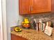 Kitchen counter with granite countertop and fruit bowl at 1506 Bunker Dr, Davenport, FL 33896