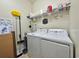 Bright laundry room with washer, dryer, and ample storage shelving at 1506 Bunker Dr, Davenport, FL 33896