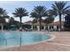 Community pool with surrounding lounge chairs at 1506 Bunker Dr, Davenport, FL 33896