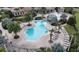 Community pool with lounge chairs and palm trees at 1506 Bunker Dr, Davenport, FL 33896