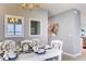 A well-lit dining room with white table and chairs, and view to the kitchen at 1593 Bull Hill Rd, Kissimmee, FL 34744