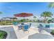 Poolside seating with tables, chairs, and umbrellas at 1593 Bull Hill Rd, Kissimmee, FL 34744