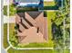 An aerial view showing the roof of a house surrounded by lush greenery in a well-maintained neighborhood setting at 15937 Birchwood Way, Orlando, FL 32828