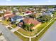 An aerial view showcasing a corner lot home in a planned community, featuring manicured lawns and mature landscaping at 15937 Birchwood Way, Orlando, FL 32828