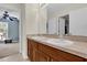 Bathroom featuring double sink vanity with wooden cabinets and a large mirror, adjacent to the bedroom at 15937 Birchwood Way, Orlando, FL 32828