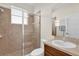 Bathroom features a tiled shower with glass doors and a vanity at 15937 Birchwood Way, Orlando, FL 32828