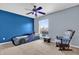 Stylish bedroom with a car-shaped bed, blue accent wall, rocking chair and window at 15937 Birchwood Way, Orlando, FL 32828