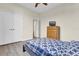 A simple bedroom featuring neutral walls, a ceiling fan, wood-look floors, and a chest of drawers at 15937 Birchwood Way, Orlando, FL 32828