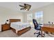 Bedroom featuring a desk, wood furniture, and a decorative ceiling fan at 15937 Birchwood Way, Orlando, FL 32828