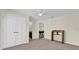 Spacious bedroom featuring neutral carpeting, a ceiling fan, double door closet, and adjacent room view at 15937 Birchwood Way, Orlando, FL 32828