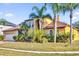 Stunning two-story home with lush landscaping and a well-manicured lawn at 15937 Birchwood Way, Orlando, FL 32828