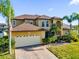 Beautiful two-story home with a spacious three car garage and lush landscaping around the house at 15937 Birchwood Way, Orlando, FL 32828