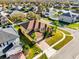 A sunny, two-story home boasts manicured landscaping and a brick-paved driveway in a residential neighborhood at 15937 Birchwood Way, Orlando, FL 32828