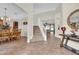 Welcoming foyer featuring tile flooring, a staircase, and views into the dining and living areas at 15937 Birchwood Way, Orlando, FL 32828