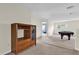 Spacious room features neutral carpet and walls, a pool table, and a wood cabinet for storage and display at 15937 Birchwood Way, Orlando, FL 32828