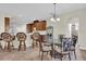 Open kitchen and breakfast nook featuring a glass table, barstools and wooden cabinets at 15937 Birchwood Way, Orlando, FL 32828