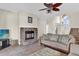 Cozy living room featuring a stone fireplace and comfortable seating at 15937 Birchwood Way, Orlando, FL 32828