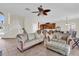 Inviting living area with staircase, comfortable couches, and seamless flow into the kitchen and dining spaces at 15937 Birchwood Way, Orlando, FL 32828