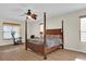 Well-lit main bedroom with a four-poster bed, ceiling fan, and wood-style flooring at 15937 Birchwood Way, Orlando, FL 32828