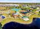 Aerial shot showcases the community park featuring playground, pond, picnic shelter, tennis court, and walking trail at 15937 Birchwood Way, Orlando, FL 32828