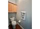 Powder room with toilet and small wooden cabinet at 1701 Sparkling Water Cir, Ocoee, FL 34761