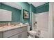 Bathroom with teal walls, granite countertop, and a shower/tub combo at 1747 Three Bars Rd, Kissimmee, FL 34744