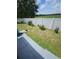 Large backyard with a white vinyl fence and grassy area at 212 Ashford Dr, Davenport, FL 33837