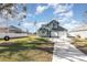 Green two-story house with attached garage and American flag at 2210 Kentucky Derby Dr, Orlando, FL 32825