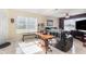 Living room with hardwood floors, a leather couch, and a wood accent table at 2210 Kentucky Derby Dr, Orlando, FL 32825