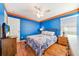 Bedroom with blue walls, wood floors, and a ceiling fan at 2249 Wyndham Palms Way, Kissimmee, FL 34747