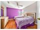 Bedroom with purple walls, two twin beds, and wood flooring at 2249 Wyndham Palms Way, Kissimmee, FL 34747