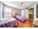 Bedroom with purple and white bedding, wood floors, and neutral walls at 2249 Wyndham Palms Way, Kissimmee, FL 34747