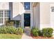 Dark-colored front door with well-maintained landscaping at 2249 Wyndham Palms Way, Kissimmee, FL 34747