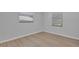 Bright bedroom with light wood floors and two windows at 2421 Healy Dr, Orlando, FL 32818