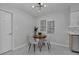 Dining area with wood table and four light-colored chairs at 2421 Healy Dr, Orlando, FL 32818